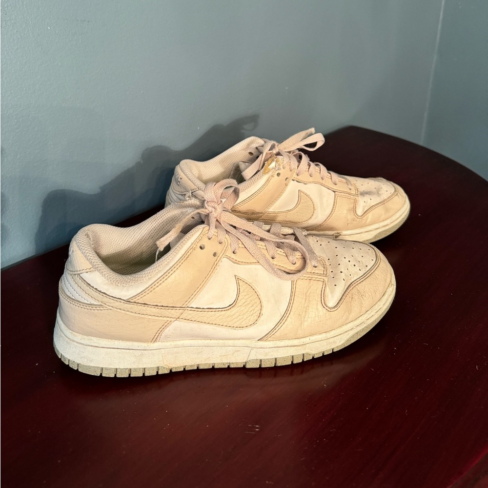 Women’s Nike Dunks. Signs of wear on top by laces. White/Beige